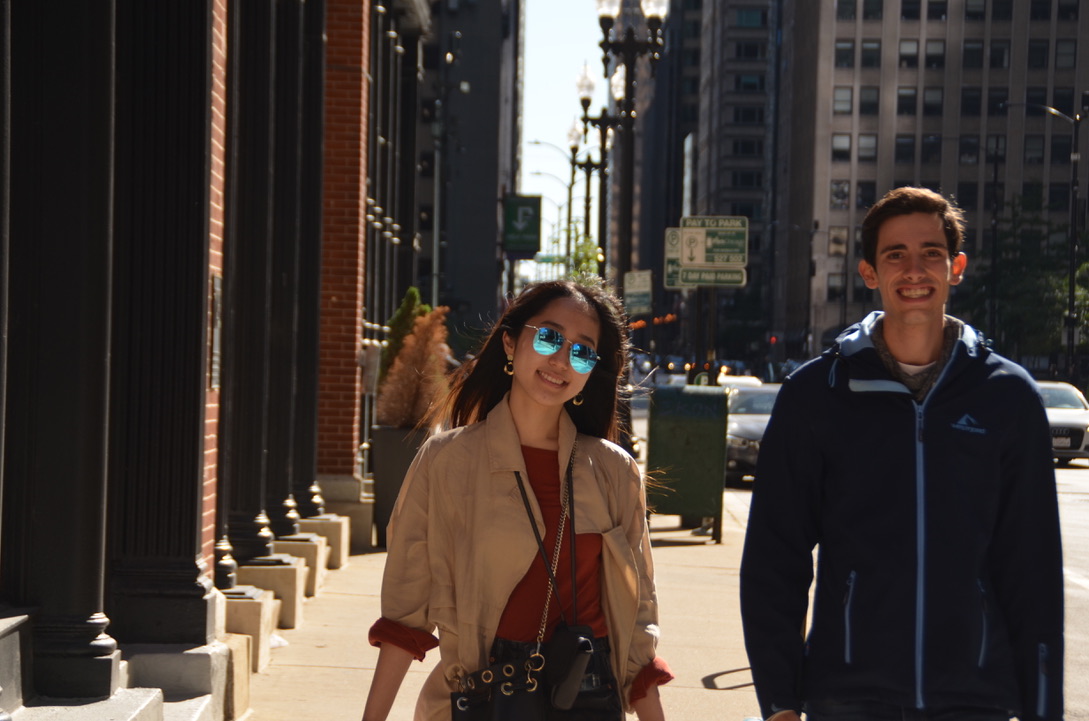 Jiyoo walking through a city with a companion
